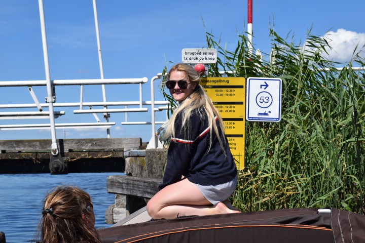 A woman kneeling on a boat