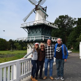 Four people in front of a windmill