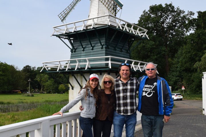 Four people in front of a windmill