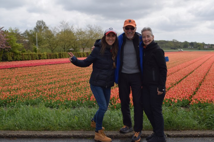 Three people in front of tulip fields